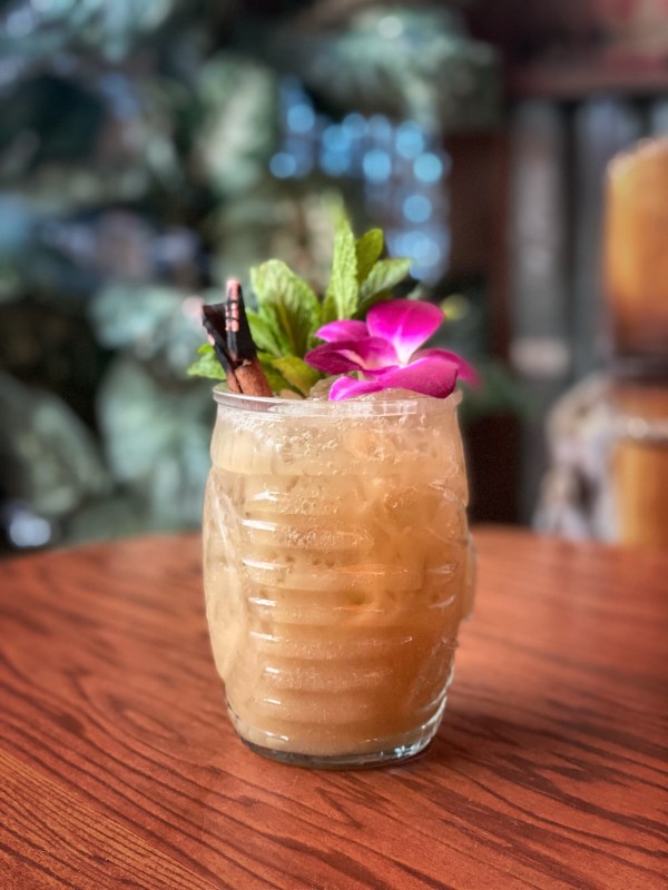 tiki cocktail with mint and orchid garnish